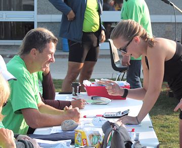 Volunteer Mike Costello (left) registers Laura Werbitsky of Collingwood for the Kincardine Terry Fox Run, Sunday morning